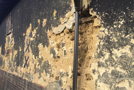 Damaged render on Suffolk barn